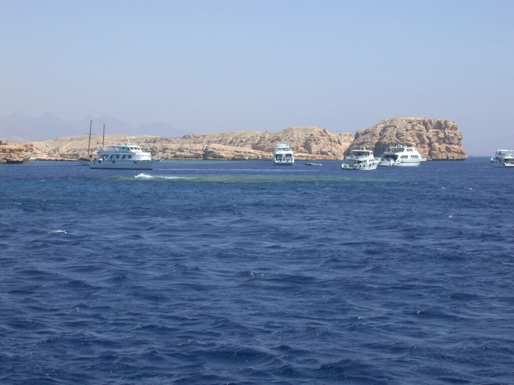 Barche da immersione all'ancora davanti alle falesie chiare di Ras Mohammed, sopra Shark e Yolanda Reef